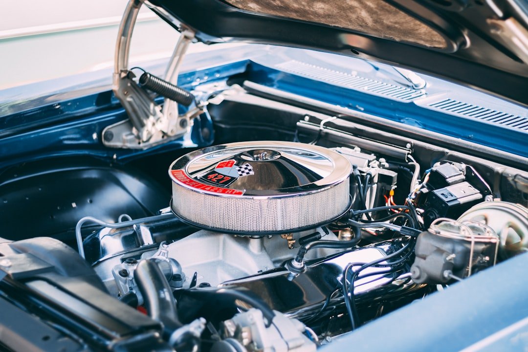 Car engine bay with hood open for service