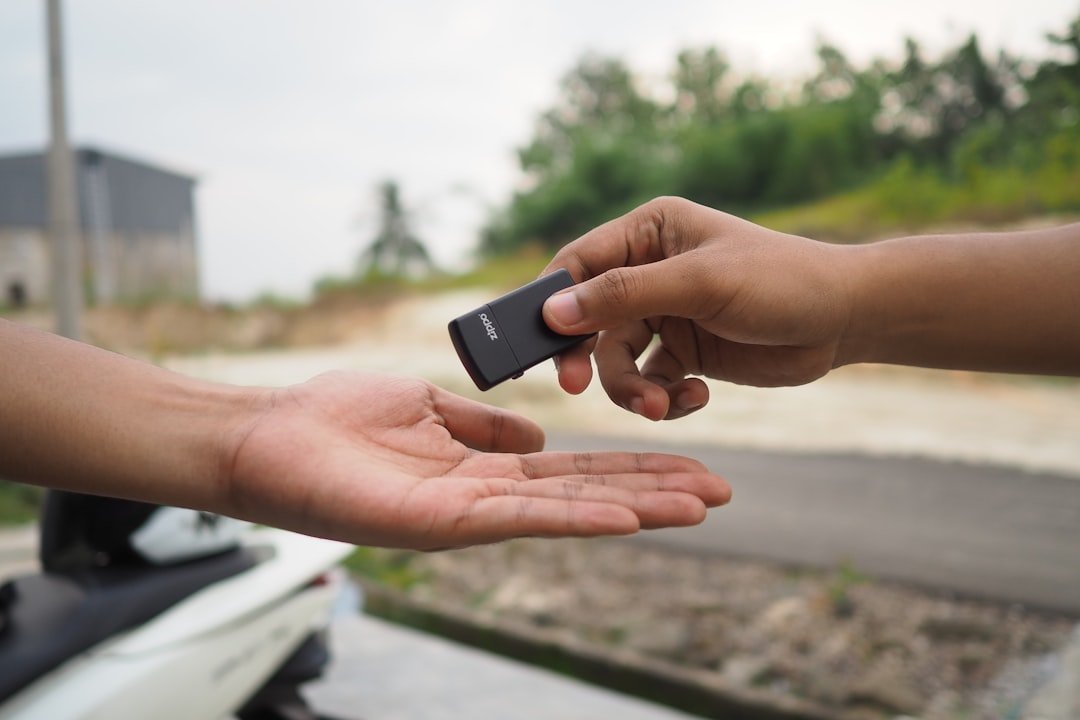 Car owner handing keys to mechanic for service