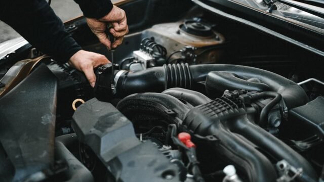 person doing DIY car maintenance in home garage