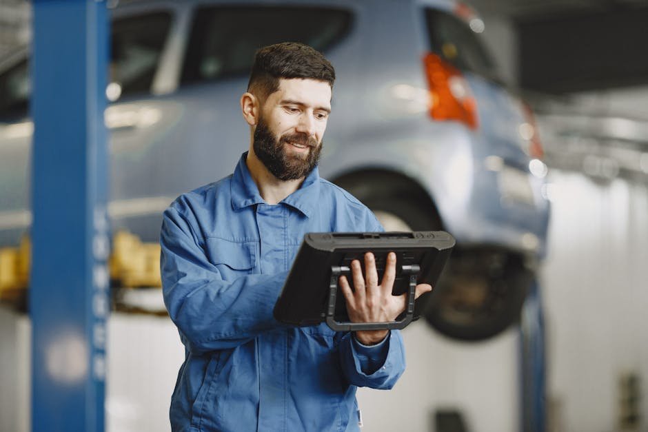 professional mechanic working on car in repair shop