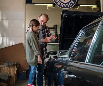mechanic talking to customer explaining car repair at auto shop