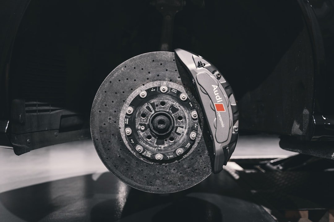 Mechanic inspecting vehicle brake components