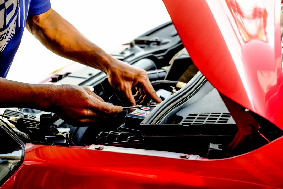 Mechanic using diagnostic computer on vehicle