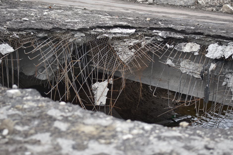 Large pothole in road that can damage vehicles