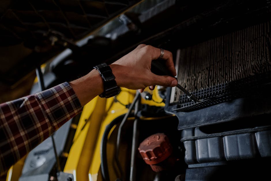 Auto mechanic working on cooling system