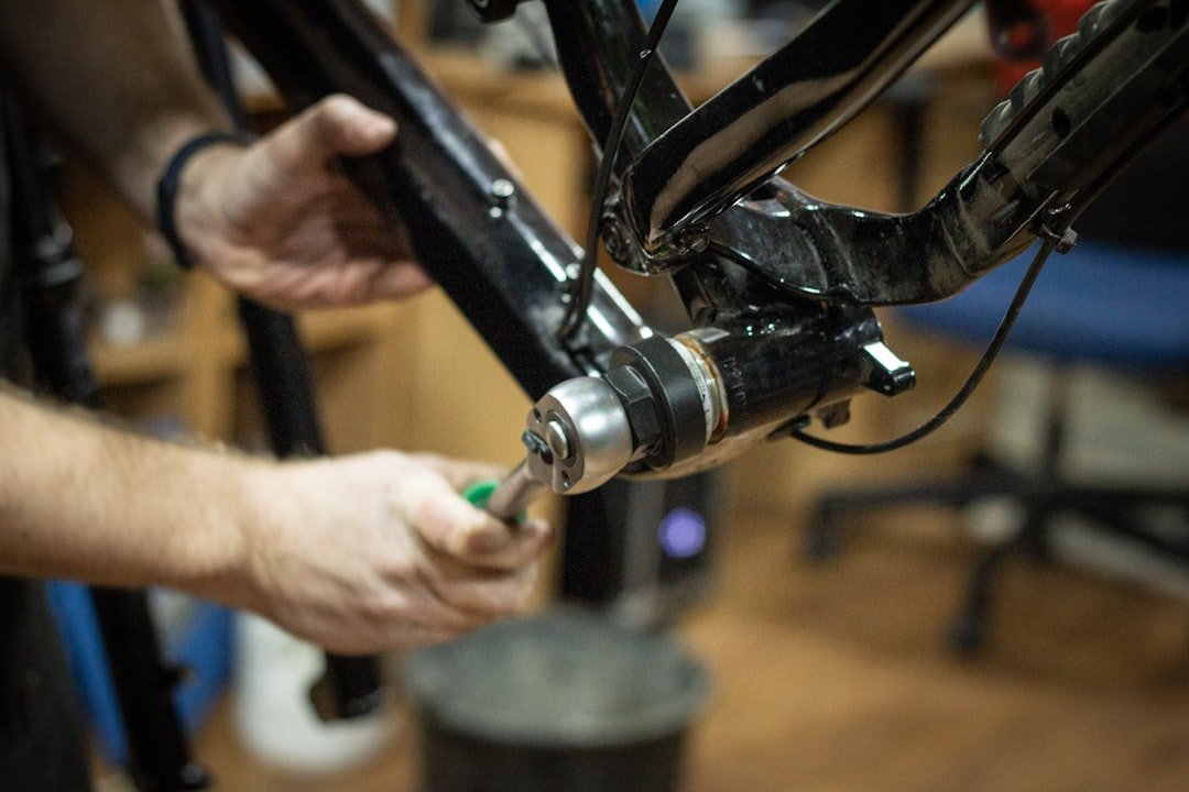 Mechanic replacing CV axle shaft on vehicle