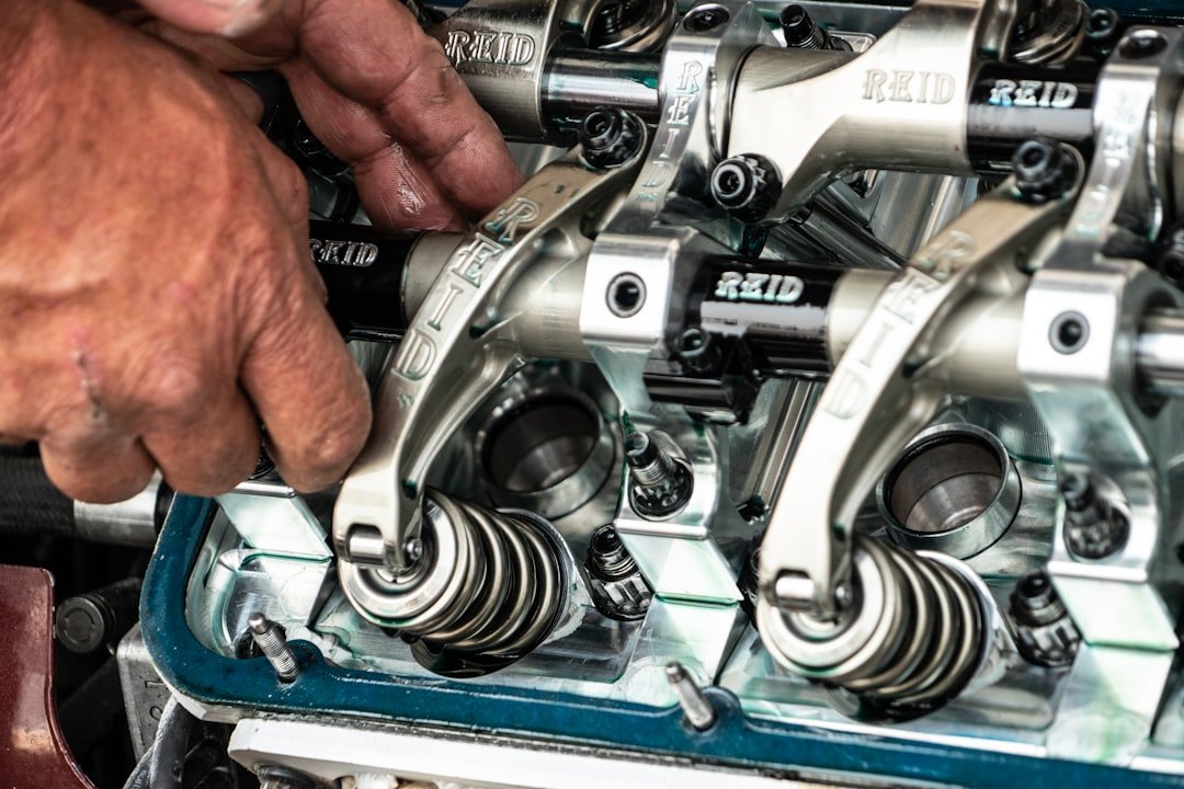 Mechanic replacing water pump during cooling system service