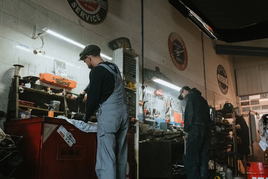 Mechanic inspecting car at repair shop