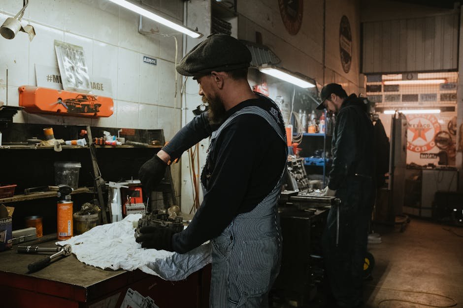 Mechanic replacing car parts and components