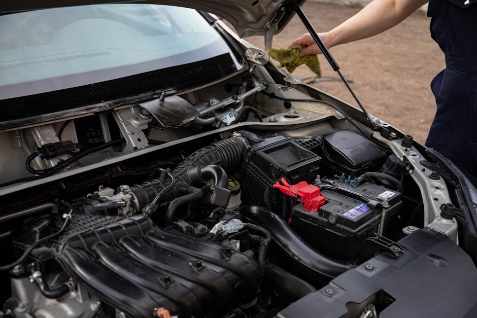 Mechanic testing car battery for winter readiness