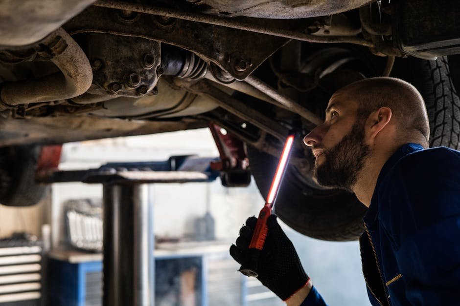 Auto repair technician performing detailed inspection