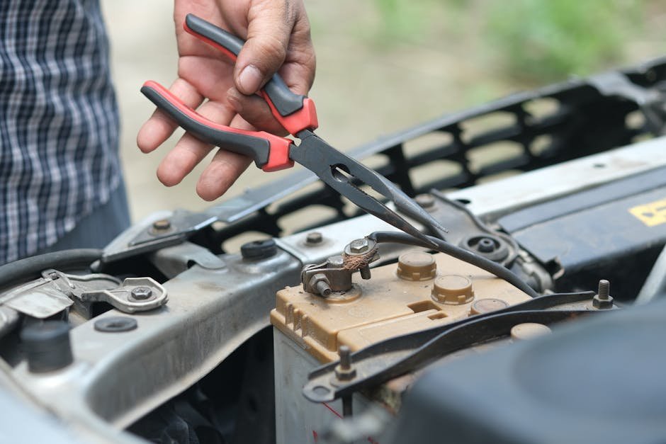 mechanic diagnosing car electrical system