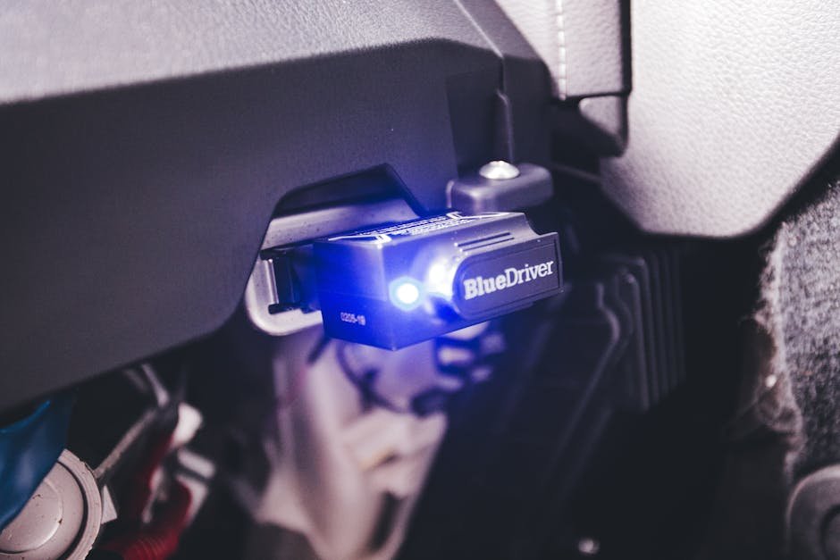 Mechanic using OBD scanner for engine diagnostics