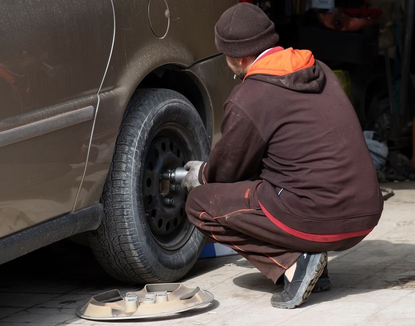 mechanic replacing wheel hub bearing assembly