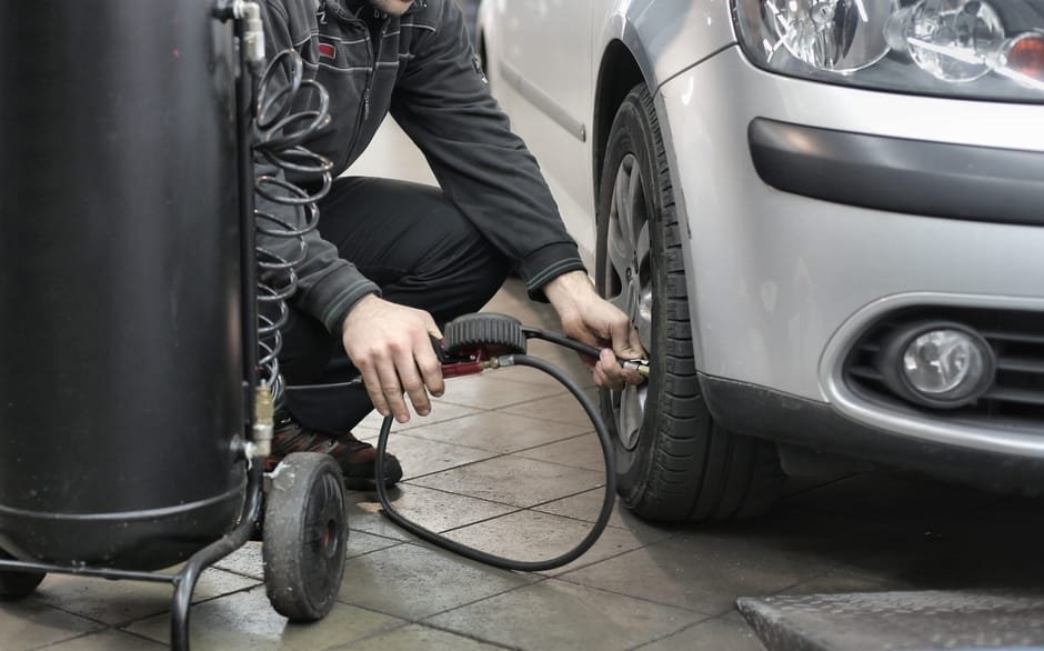Mechanic performing pre-trip vehicle inspection