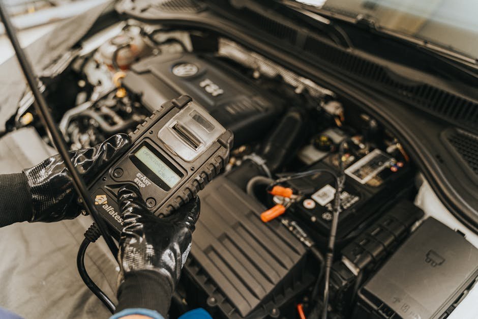 technician using multimeter to test car battery drain