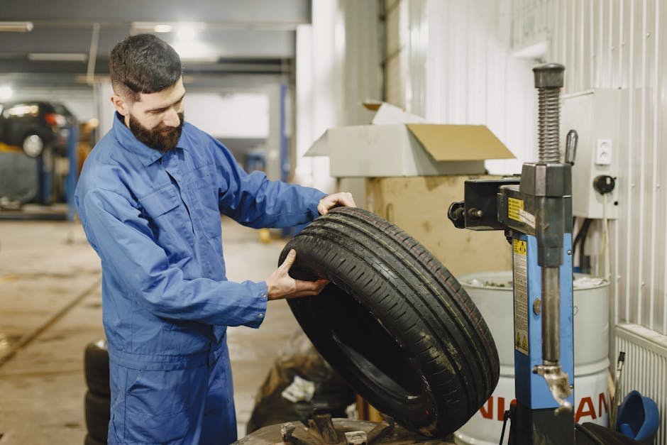 Mechanic checking car for pothole damage