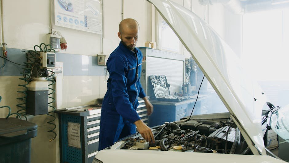 Mechanic inspecting Honda Civic engine at Norm's Auto Clinic
