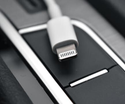 OBD-II scanner plugged into vehicle diagnostic port under dashboard
