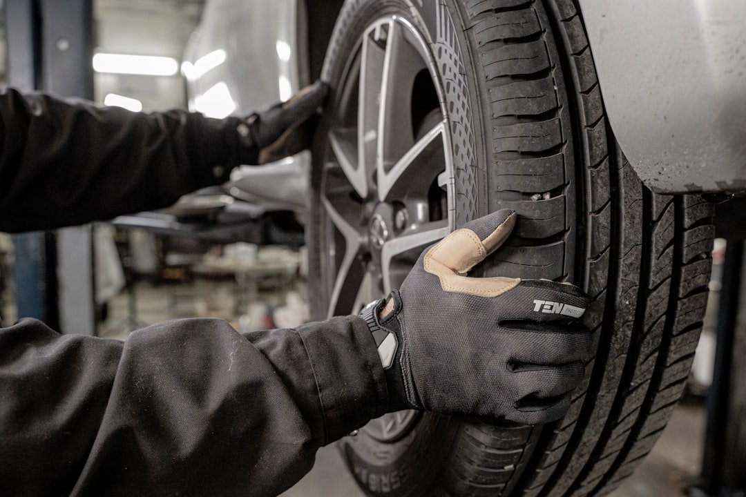 Tire rotation and wheel alignment service being performed